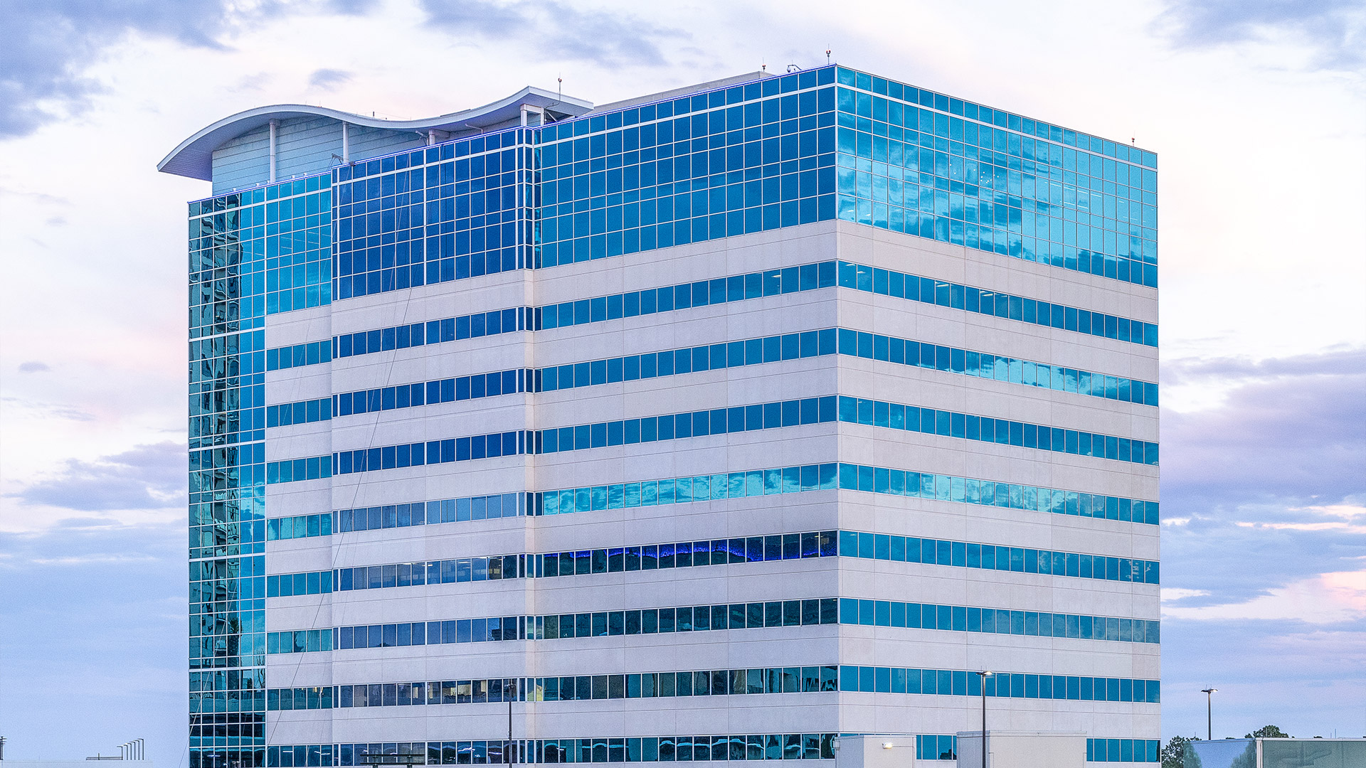 Exterior of the blue glass office tower at 945 Bunker Hill Road