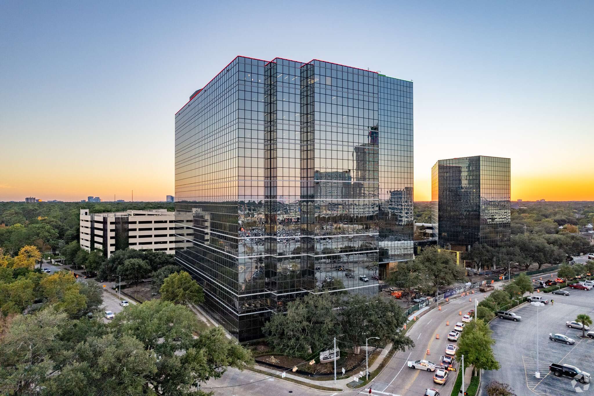 Aerial view of the mirrored-glass office towers at 840 Gessner Road at sunset