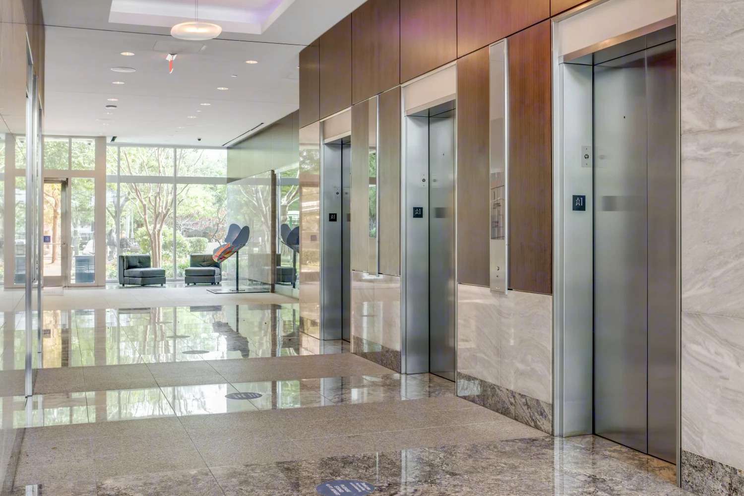 Elevator lobby at 945 Bunker Hill Road with stone-clad walls and a polished floor