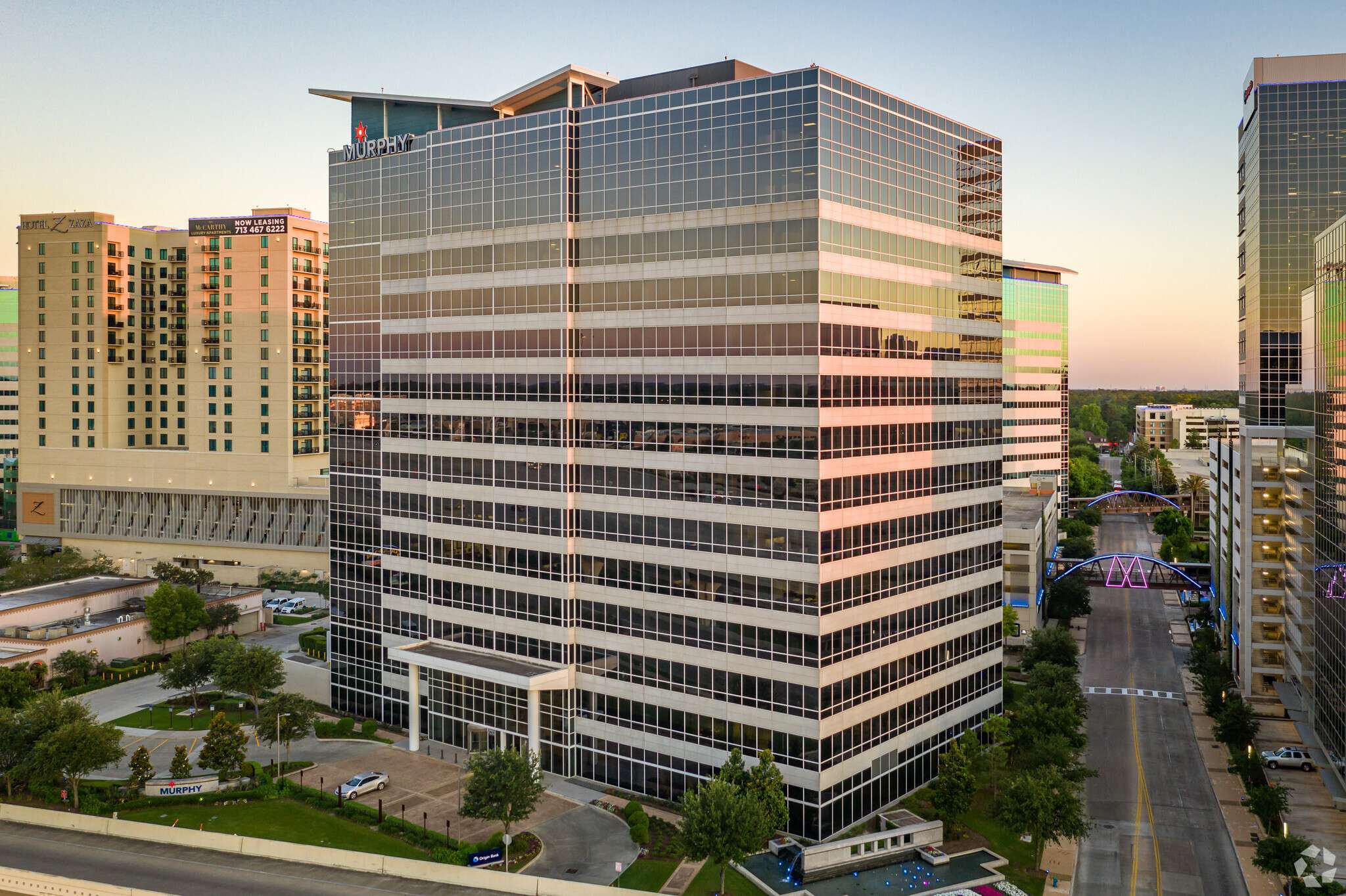 Aerial view of the Murphy Building at 9805 Katy Freeway at sunset, with neighbouring buildings behind