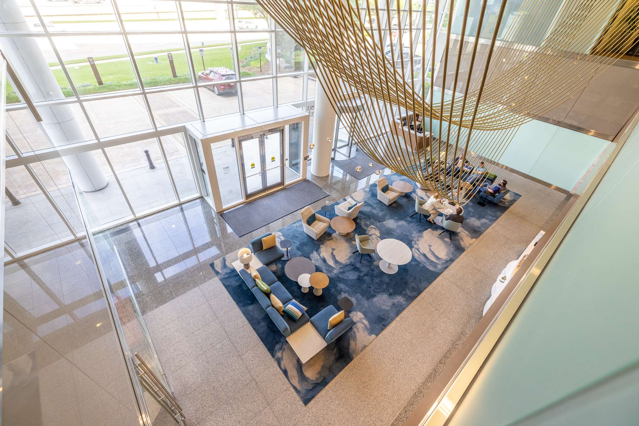 Overhead view of the lobby at the Murphy Building, with a gold sculptural ceiling installation above the seating