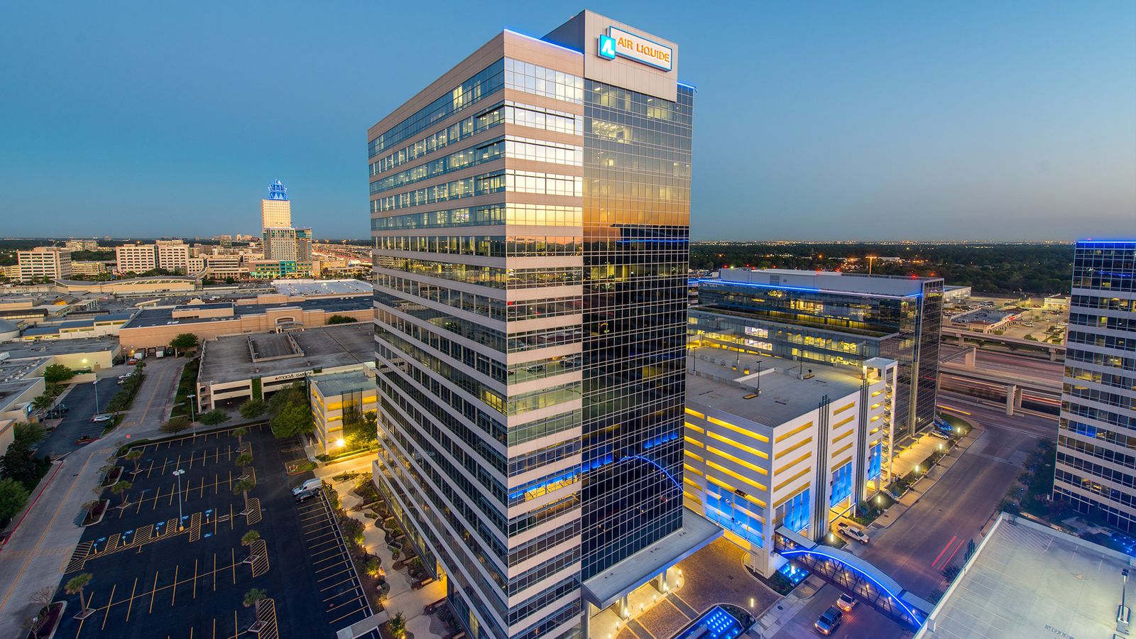 Aerial view at dusk of the office towers around 9811 Katy Freeway, Air Liquide Center South