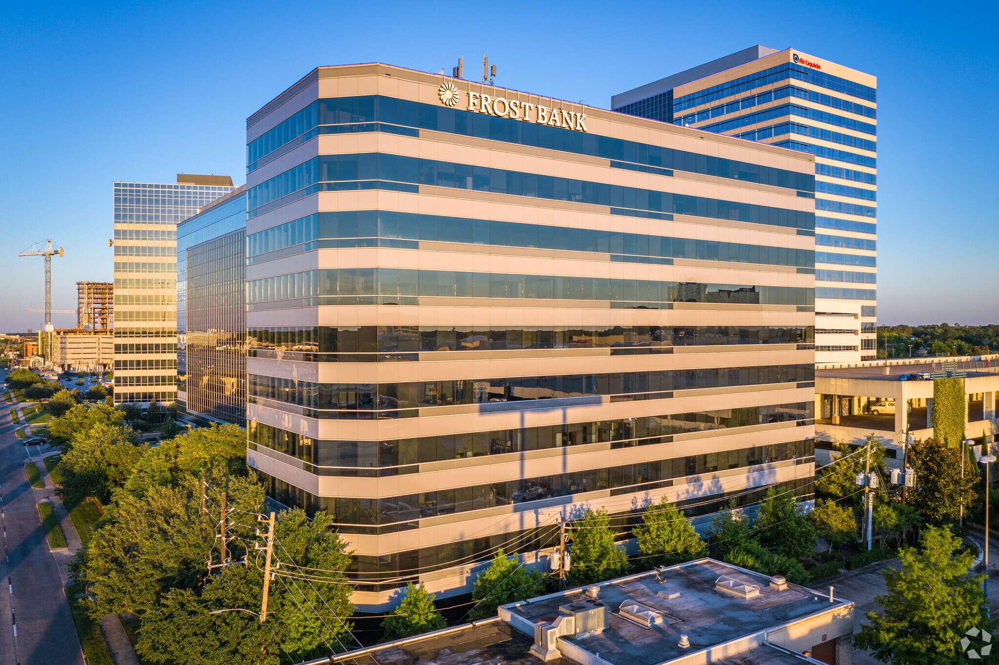 Aerial view of the office building at 9821 Katy Freeway with neighbouring buildings and trees