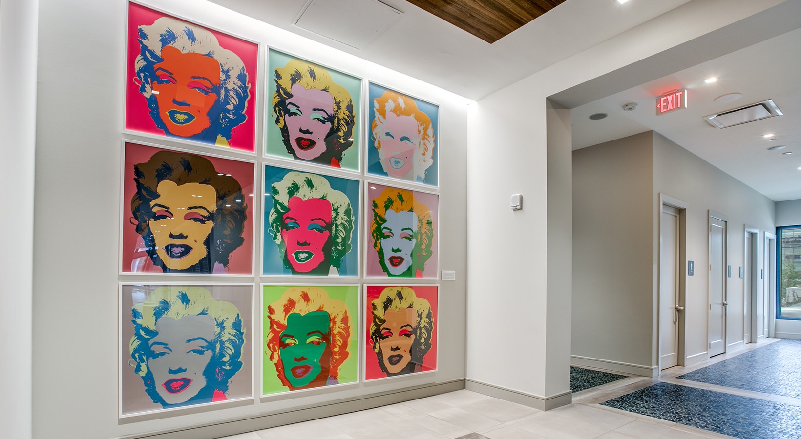 Grid of nine Pop Art Marilyn Monroe prints displayed on a lobby wall at a MetroNational property