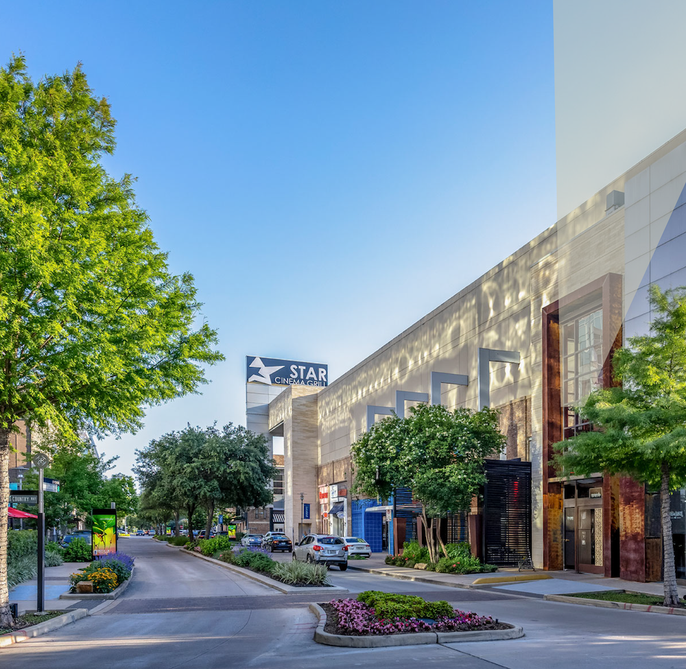Street view of the shops and restaurants at CityCentre, lined with trees