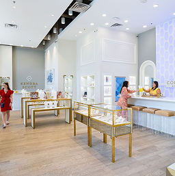 Interior of a jewellery store at CityCentre, with lit display cases and staff assisting customers