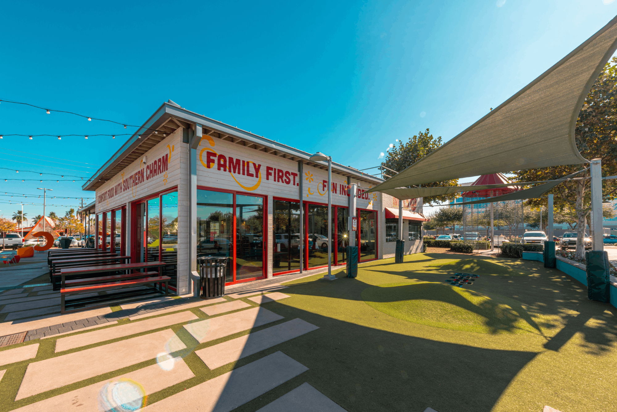 Retail buildings at Greenside with shade canopies and benches along a landscaped walkway