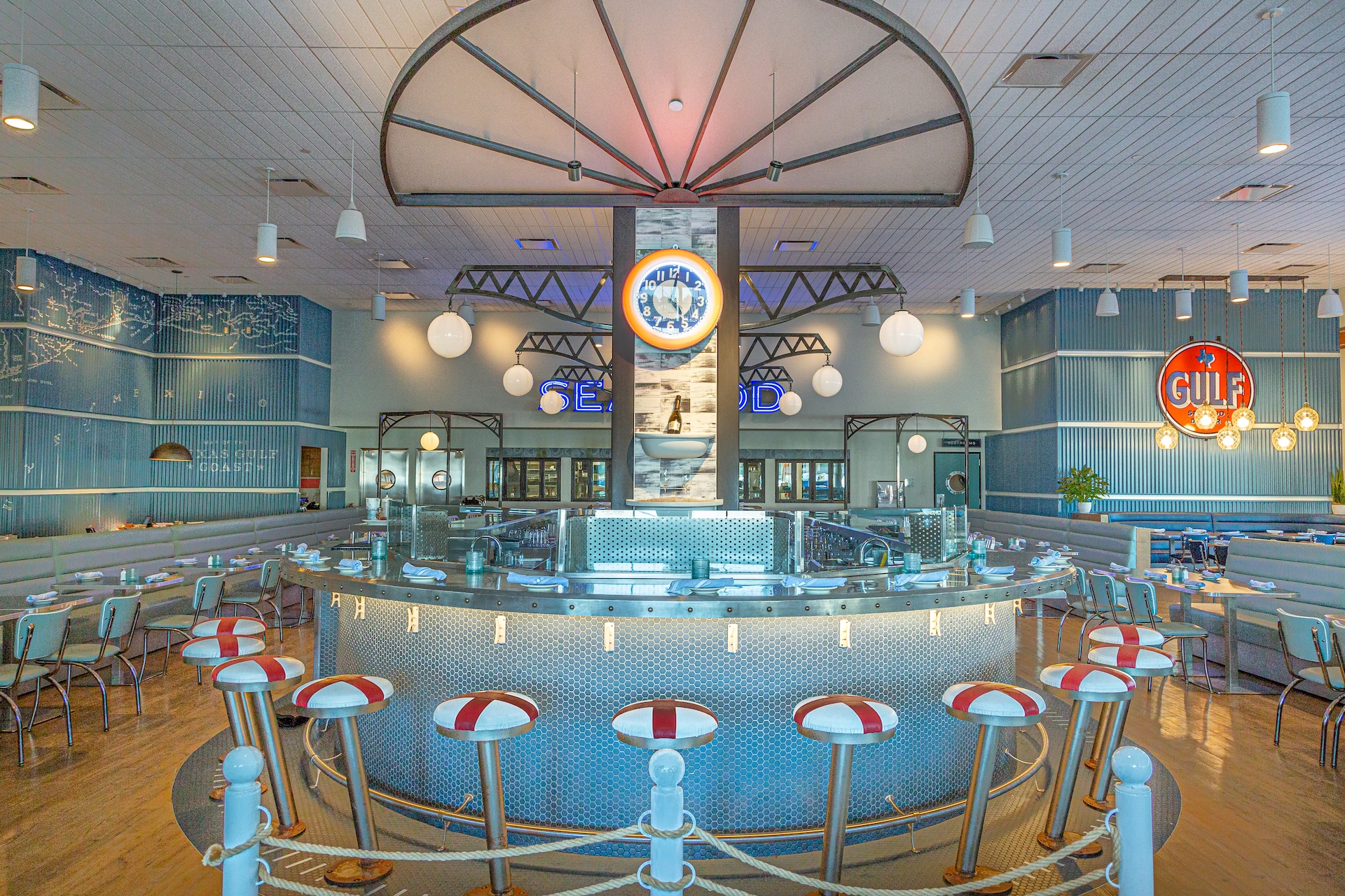 Curved light blue counter and retro seating inside Goode Co. Seafood at Katy Retail Centers