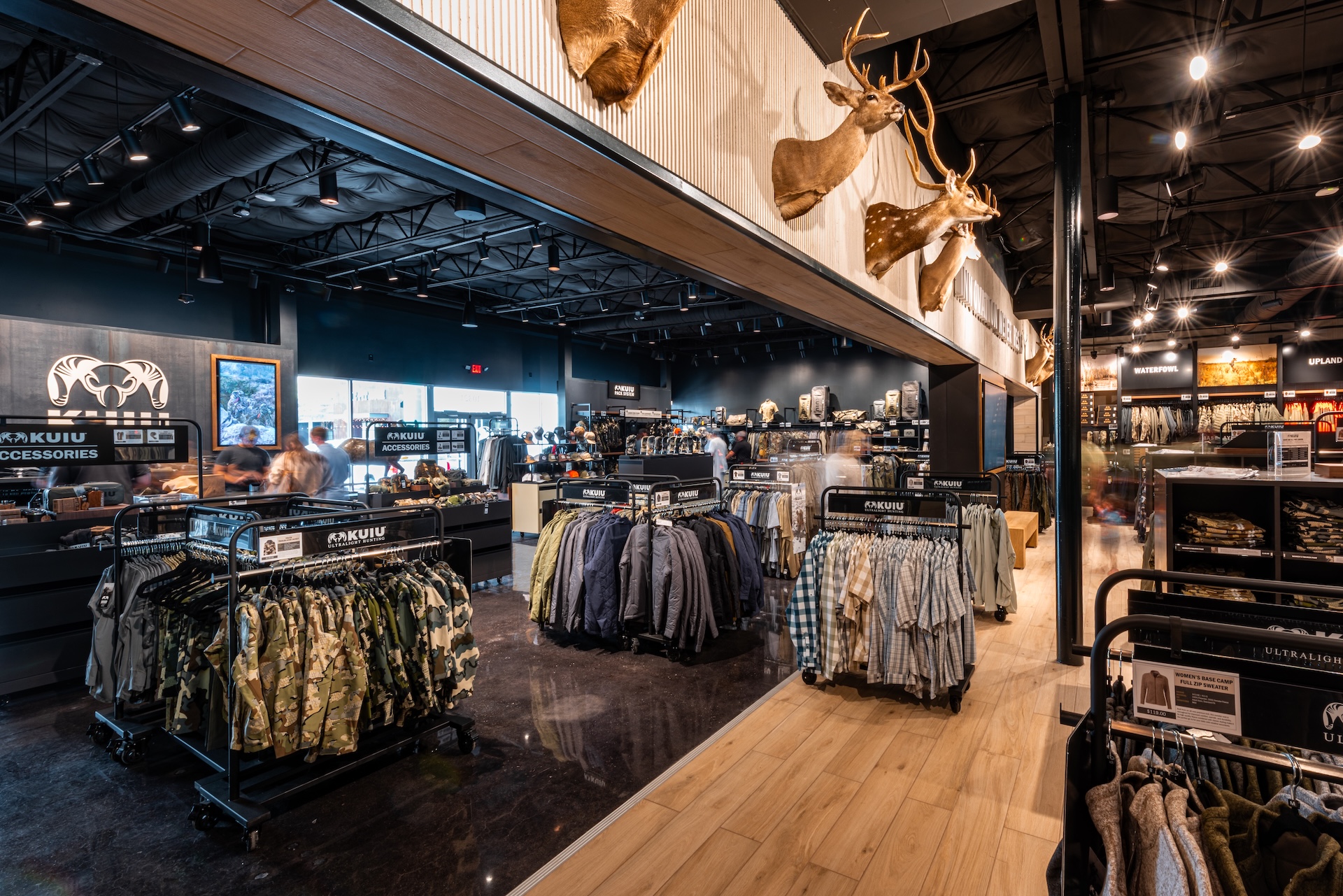 Sales floor of the KUIU hunting apparel store at Katy Retail Centers, lined with camouflage clothing racks