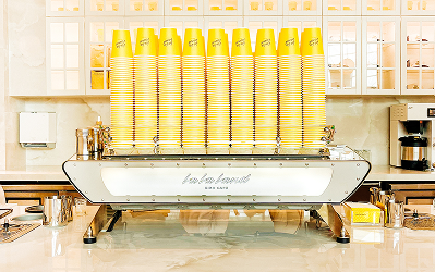 LALALAND Rows of yellow bottled drinks displayed on a cafe counter at M-K-T Heights