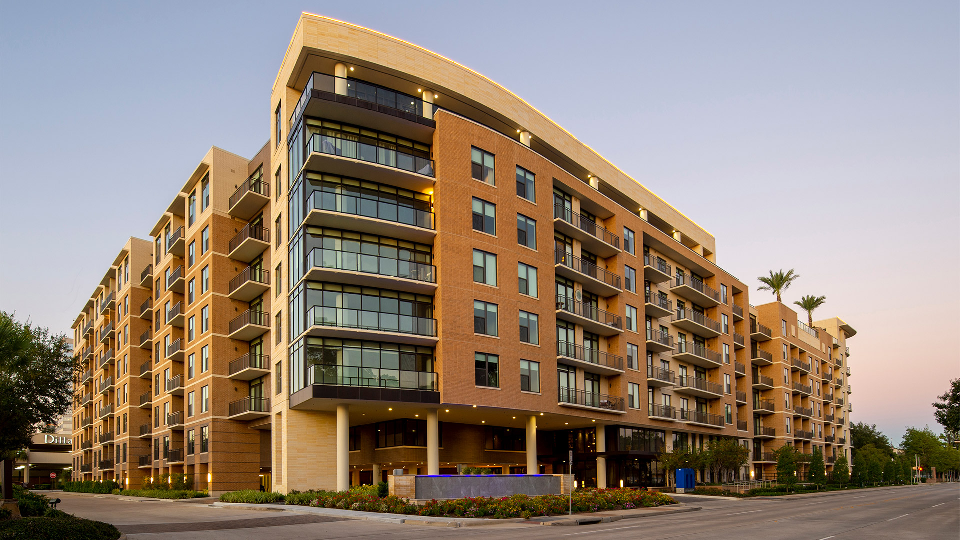 Exterior of The McAdams, a multi-story residential building photographed at dusk