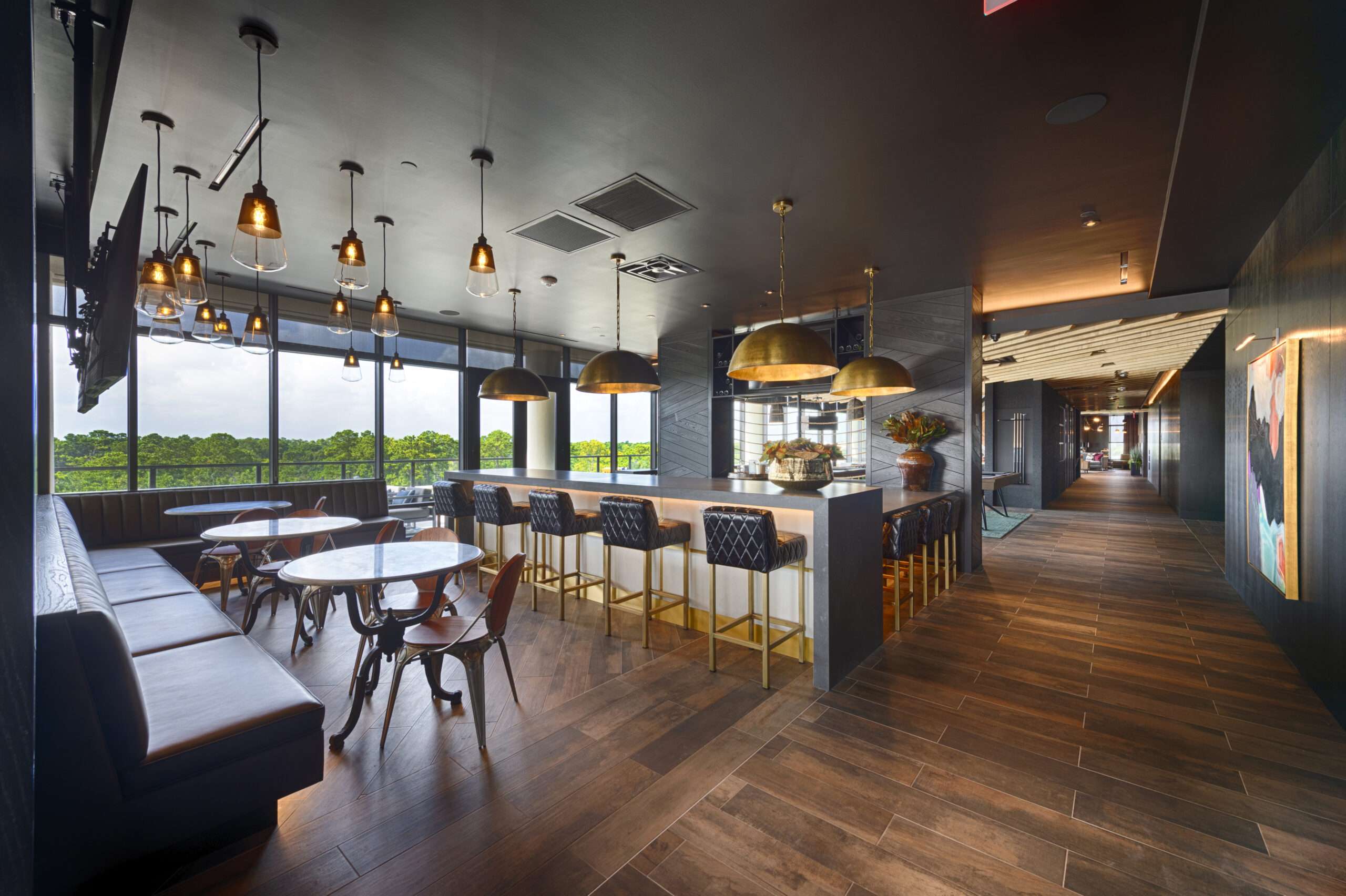 Resident kitchen and bar lounge at The McAdams with pendant lighting and banquette seating