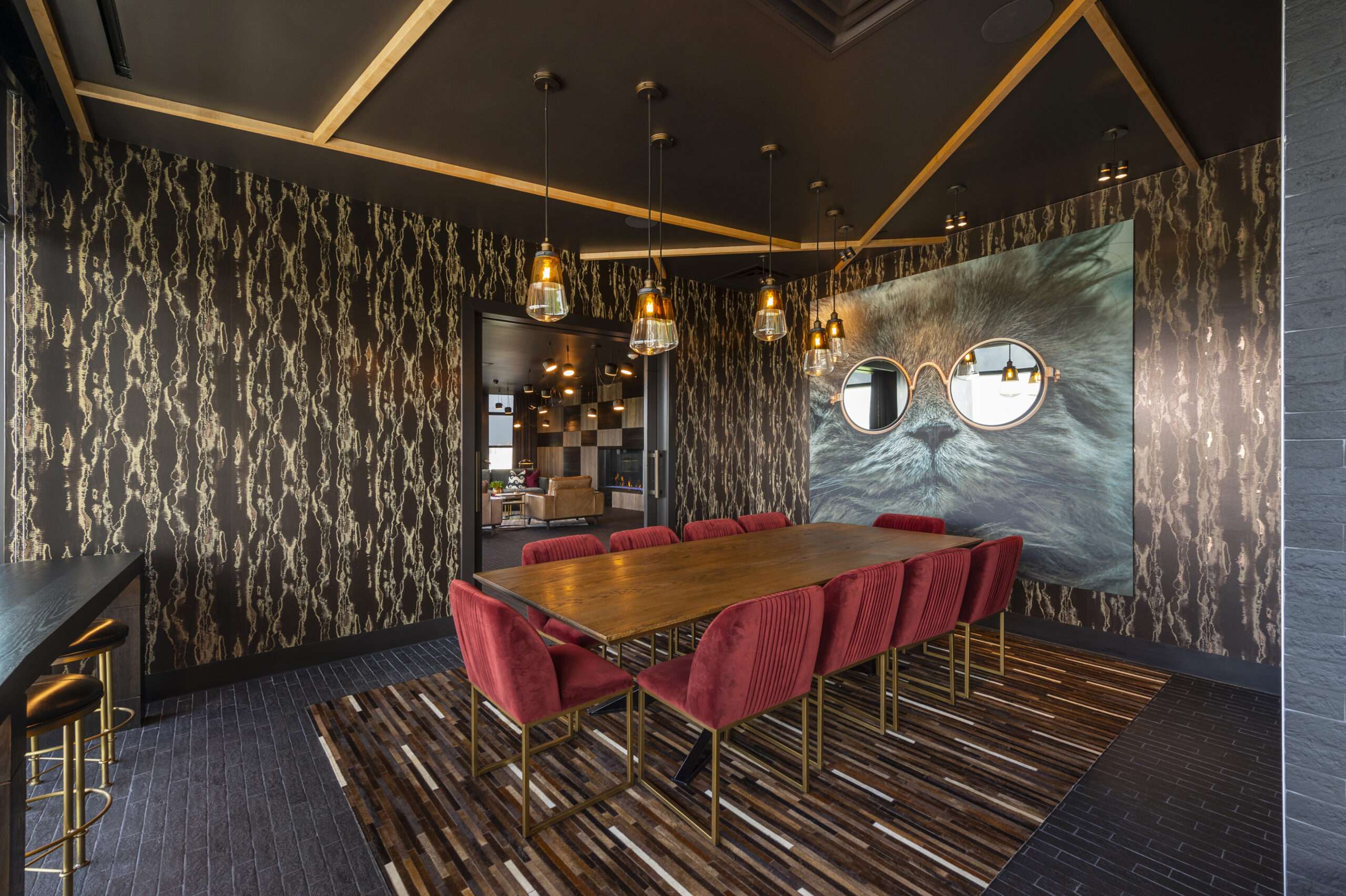 Private dining room at The McAdams with a long table, patterned wallcovering and pendant lights