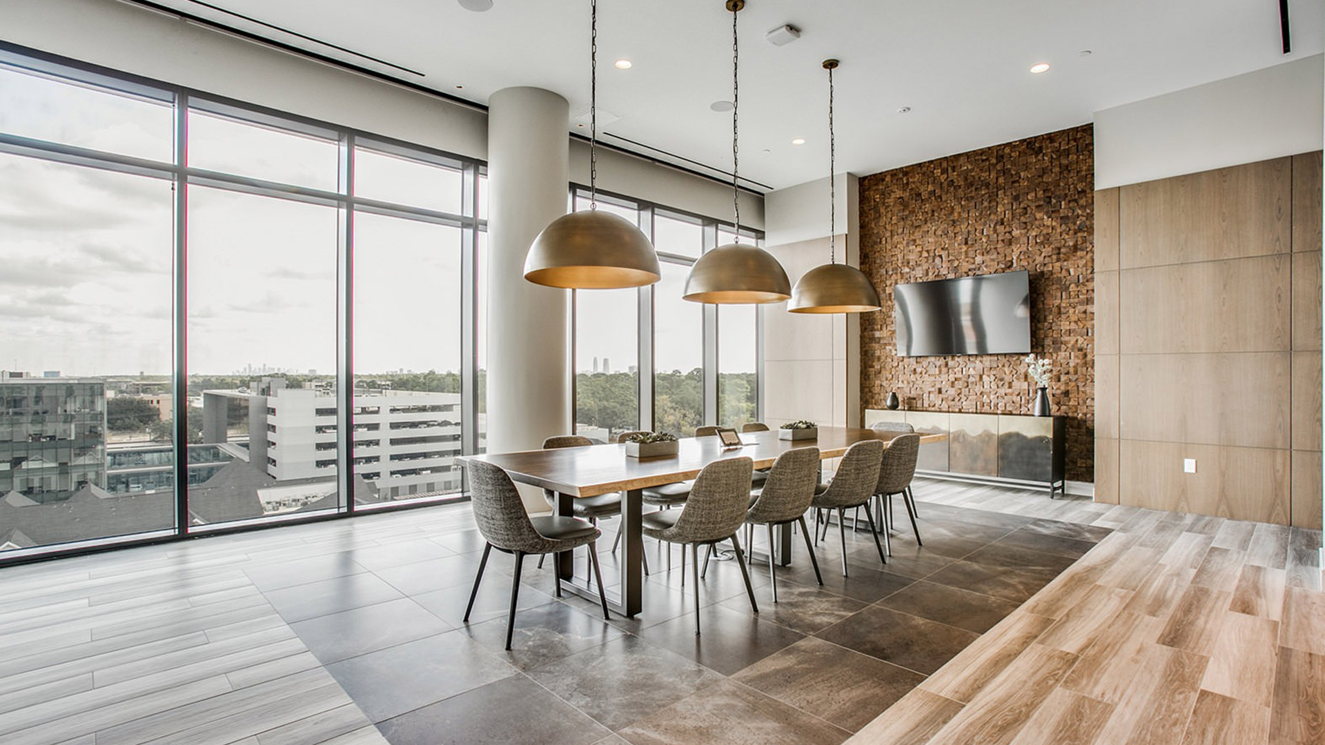 Private dining room at The McKinley with a long table, pendant lighting and a window wall