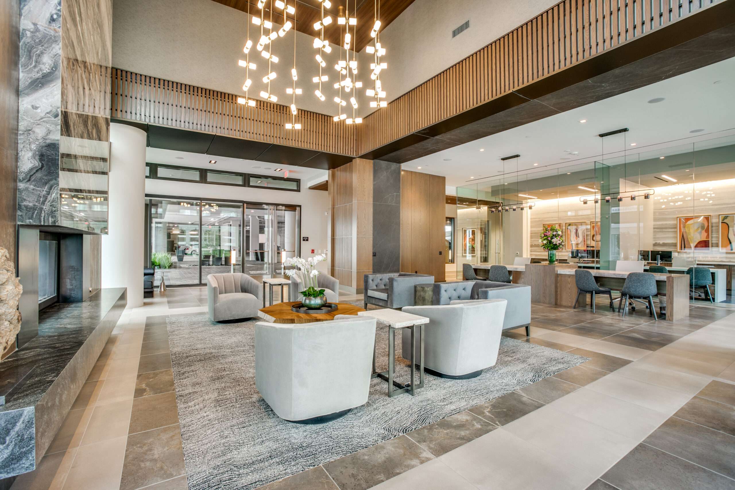 Double-height lobby lounge at The McKinley with a chandelier and grouped seating