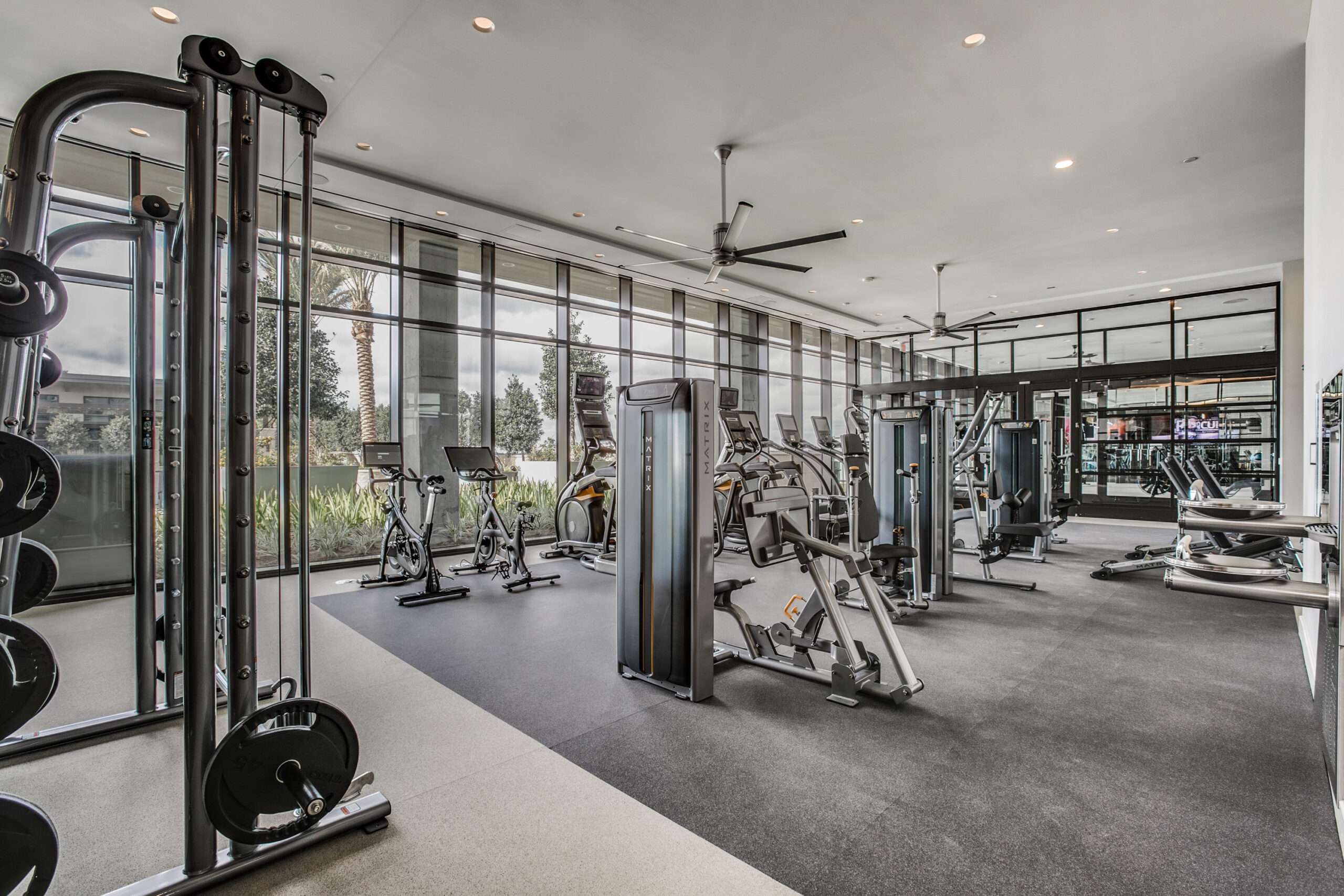 Fitness center at The McKinley with weight machines, free weights and a mirrored wall