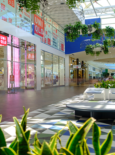 Storefronts and seating along a concourse at Memorial City Mall