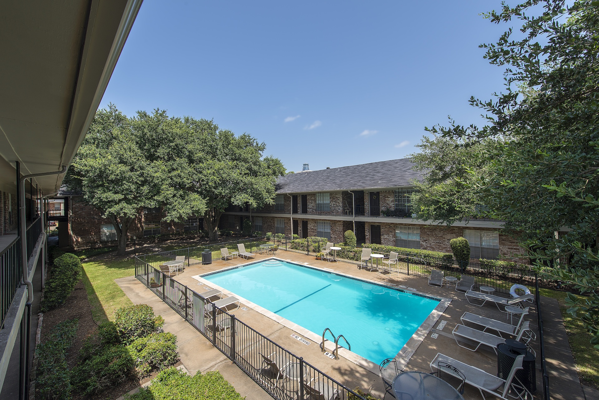 Memorial City Apartments - Houston, TX Elevated view of the pool and courtyard at Memorial City Apartments from a resident balcony