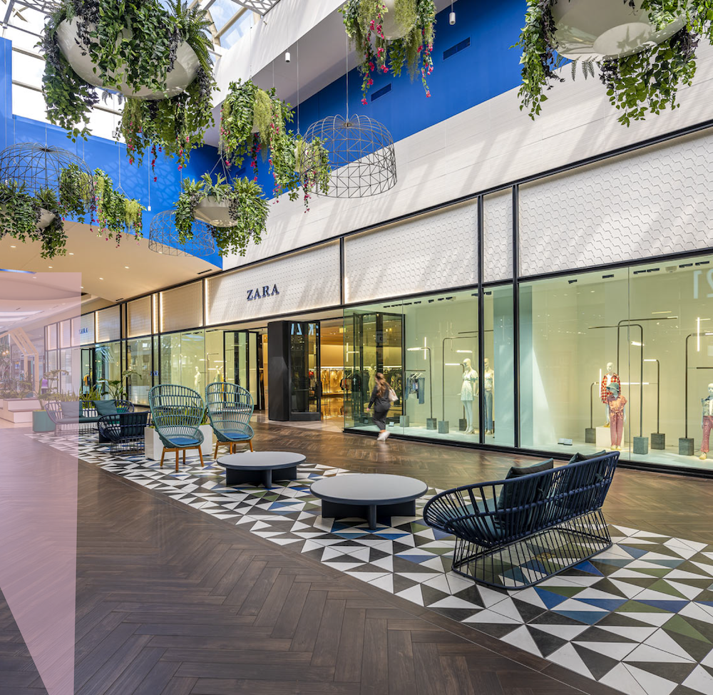 Retail walkway at Memorial City Mall with patio seating and patterned paving