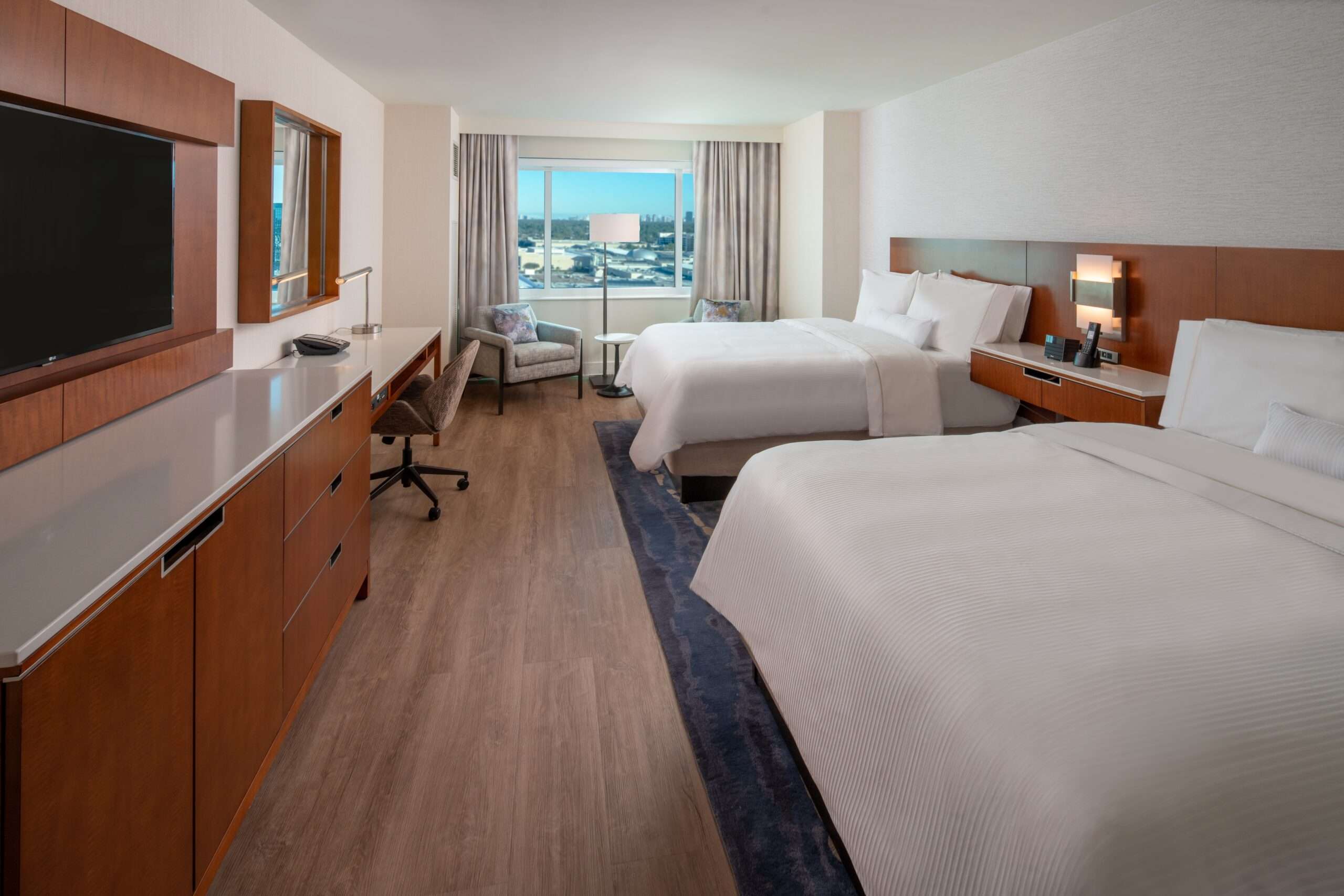 Double queen guest room at The Westin Memorial with two beds and a work desk