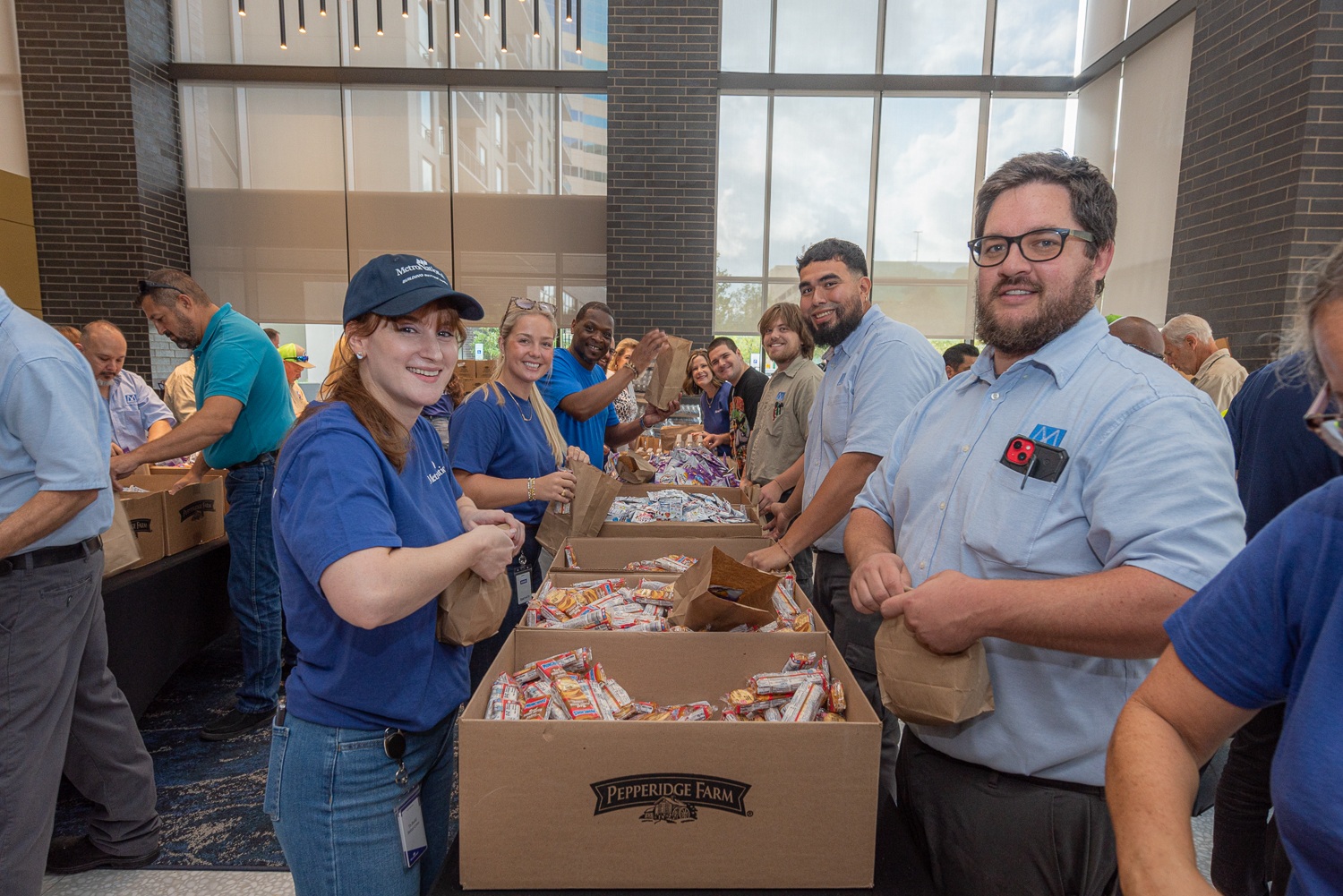 MetroNational employees packing paper grocery bags at a community service project