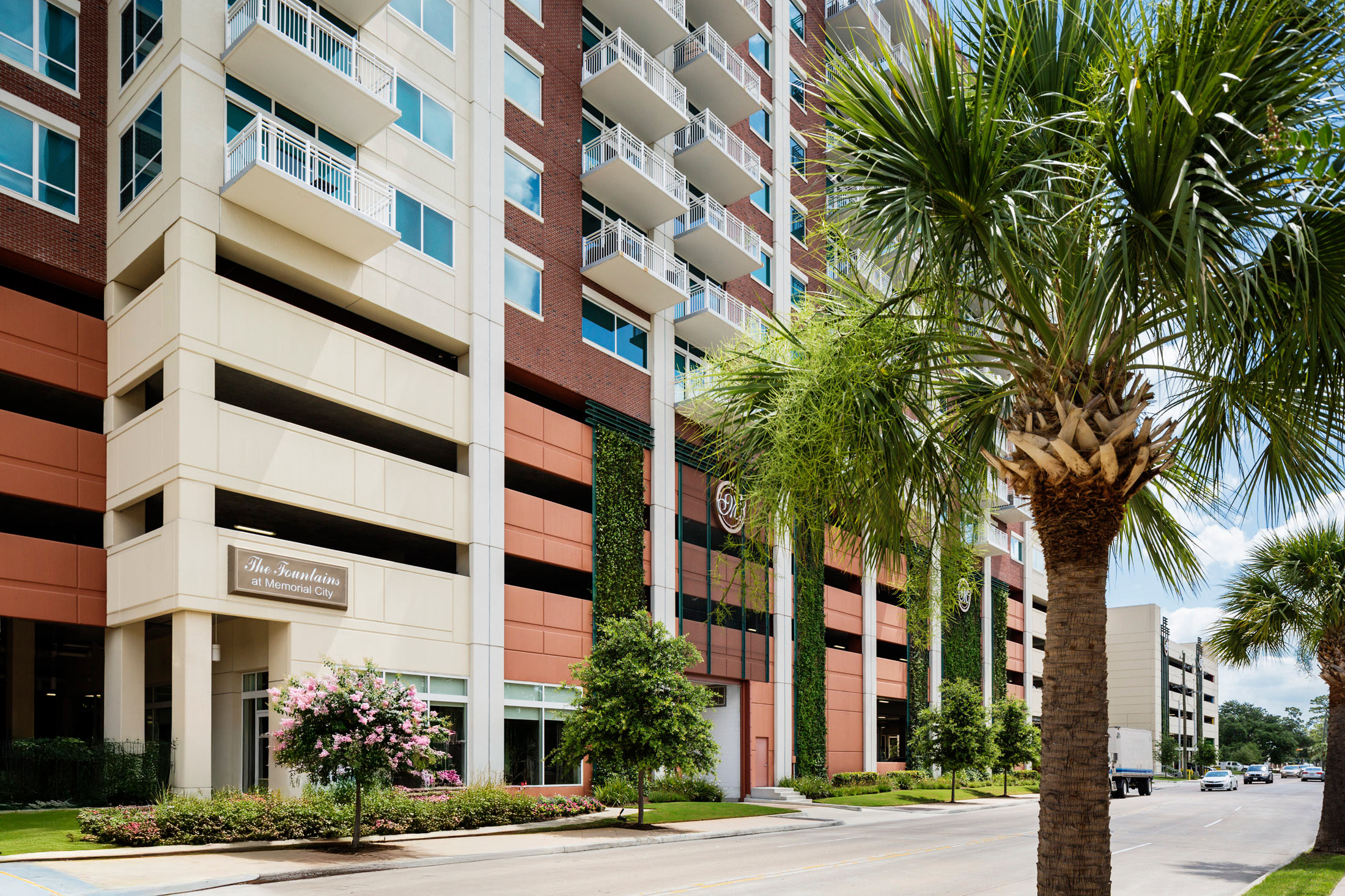 Street-level view of The Fountains with palm trees along the sidewalk