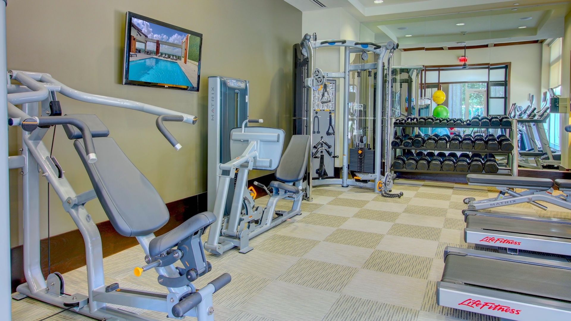 The Fountains Fitness Fitness room at The Fountains with weight machines, free weights and a wall-mounted television