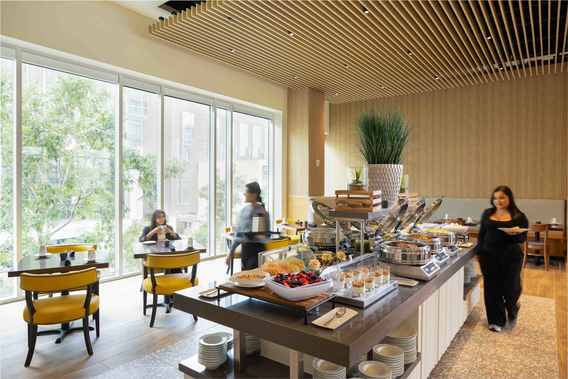 Guests serving themselves at the breakfast buffet at The Moran Hotel